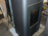 a black oven sitting on top of a pallet in a warehouse