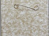a picture of a safety pin on the wall