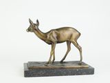 bronze statue of a deer on a marble base on a white background