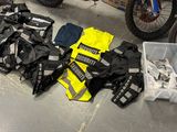 many different types of clothing on the floor next to a bike