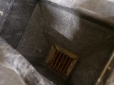 an image of a small bathroom with a drain in the floor