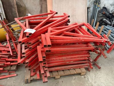 a pile of red wooden pallets sitting on the ground