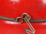 a close up of a red fire hydrant with a hook on it