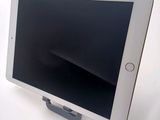 a tablet that is sitting on a stand on a table