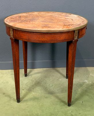 an old wooden table with a wooden top on a green floor