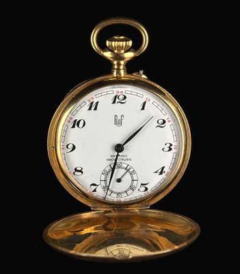 an image of a gold pocket watch on a black background