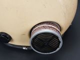 a close up of a gas mask on a black surface