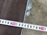a measuring tape that is on top of a piece of metal