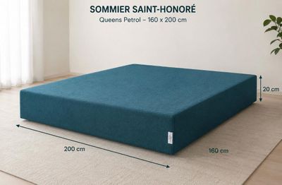 an image of a bed with a blue cover on it
