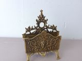 brass plate with ornate design on top of it on a table