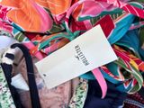 a pile of clothes with a label on it