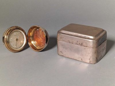 a small metal box with a clock inside of it