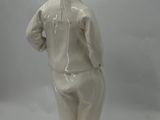 a white statue of a woman with a hat on her head