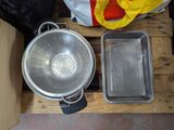 two pans and a colander sitting on a pallet