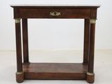an old wooden table with a marble top and brass handles