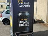 a black box with a crown on it sitting in a parking lot