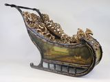 a metal sleigh with a painting on it