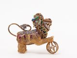 a gold lion with a wheel on a white background