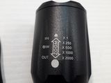 a close up of a black microphone on a white surface