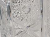 a clear glass vase with a flower design on it