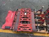 an image of a red tractor on a pallet in a parking lot