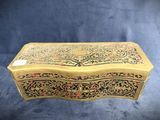 an old wooden box with a floral design on it