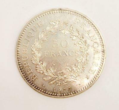 an image of a silver coin with a wreath on it