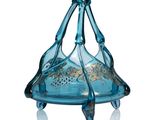 a blue glass object that is sitting on a white surface