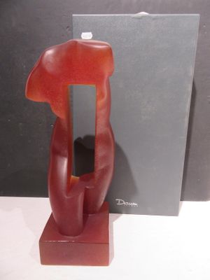 a red sculpture of a dog on a stand