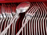 a lot of silverware in a red box