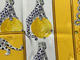 a picture of a yellow table cloth with leopards on it