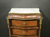 an antique wooden chest of drawers with marble top