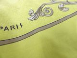 a close up of a yellow shirt with the word paris on it