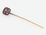 a close up of a purple and black diamond pin