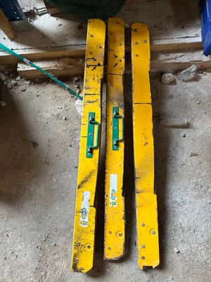 two yellow skis sitting on the floor in the garage