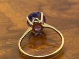 gold ring with amethorate and amethorate stones on a wooden table
