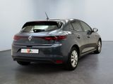 the rear end of a grey car parked in a room