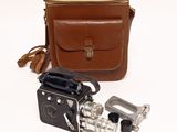an old camera with a leather case and a metal object