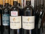 bottles of wine are lined up on a shelf in a store