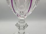 a purple wine glass sitting on top of a table