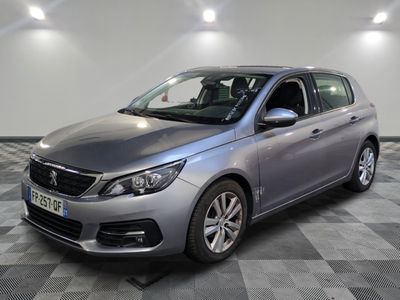 the grey car is parked in the garage on a checkered floor