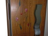 a wooden cabinet with a mirror and a mirror on it