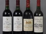 three bottles of red wine are lined up on a table