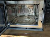 a microwave that is sitting on a wooden table