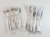 a lot of forks and spoons wrapped in plastic bags