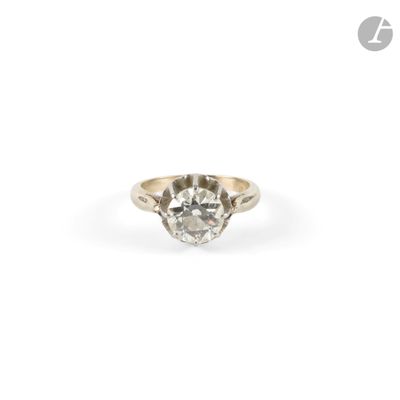 a close up of a diamond ring on a white background