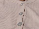 a close up of a white shirt with a tag on it