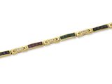 un gros plan sur un bracelet en or orné de perles vertes et rouges
