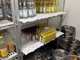 many kegs that are on the shelves in the room