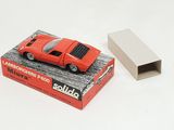 a red toy car sitting on top of a box